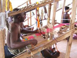 Weaving Kente on a hand made loom in the Kente village of Adanwomase, Ghana